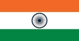 Three horizontal bands of orange, white and green with a dark blue chakra centered in the white band.